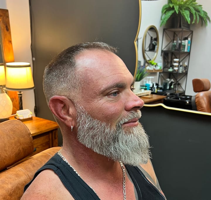 A full grey beard shaped by Sara Jane, side profile